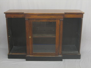 A William IV rosewood and breakfront bookcase, the centre section fitted adjustable shelves and enclosed by a glazed panelled door, raised on a platform base 65 1/2"