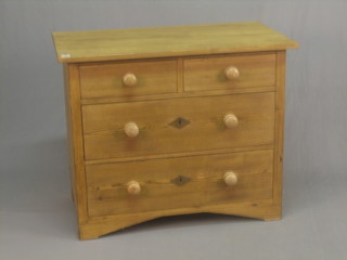 A pine chest of 2 short and 2 long drawers with tore handles, raised on block supports 39"