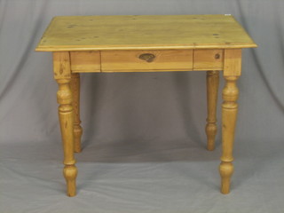 A rectangular pine kitchen table, the frieze fitted a drawer, raised on turned supports 39"