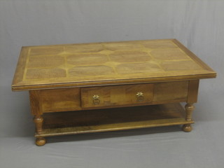 A rectangular oak 2 tier occasional table, raised on bun feet 51"