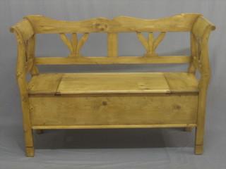 A stripped and polished pine settle with hinged lid 50"