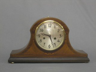 A 1930's 8 day striking mantel clock with silvered dial and Arabic numerals contained in an Admiral's hat shaped case
