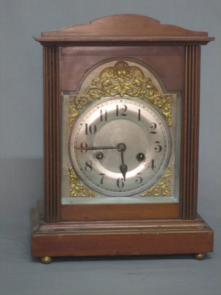 An Edwardian 8 day striking bracket clock with silvered dial and Arabic numerals contained in a walnut case
