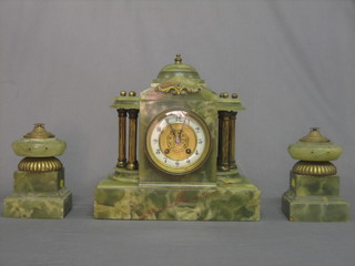 An Edwardian onyx clock garniture comprising striking clock with porcelain dial and Arabic numerals contained in an architectural style onyx case with 2 side pieces