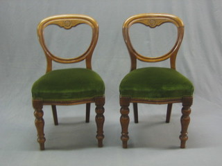 A set of 4 Victorian bleached mahogany balloon back dining chairs with shaped mid rails