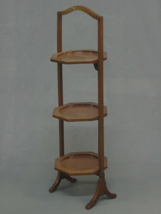 A 1930's walnut octagonal 3 tier folding cake stand
