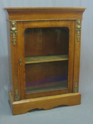 A Victorian walnut Pier cabinet the interior fitted shelves enclosed by a glazed panelled door raised on a platform base 31"