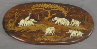 An oval Eastern hardwood plaque inlaid ivory elephants 19"