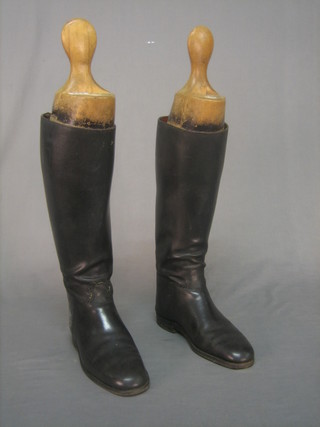 A pair of black leather riding boots approx. size 7 1/2 - 8, complete with wooden trees marked Peel & Co Wigmore Street
