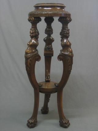 A 19th Century carved "Italian" walnut jardiniere stand supported by 3 bust figures, raised on cabriole supports 48"