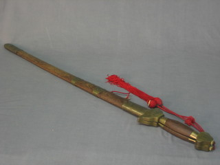 A reproduction Oriental sword the blade signed complete with hardwood scabbard