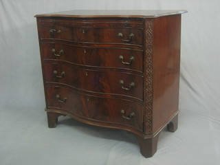 A handsome 19th Century mahogany chest of serpentine outline fitted a brushing slide above 4 long graduated drawers with canted sides and blind fret work frieze, raised on bracket feet 40"