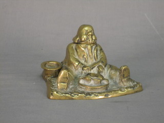 A cast brass ink well in the form of a seated stout gentleman 6"
