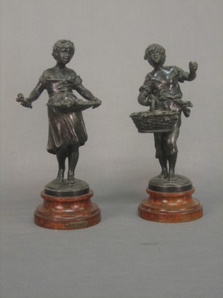 A pair of 19th Century spelter figures in the form of boy and girl gardeners 9", raised on socle bases