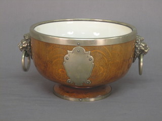 A circular oak fruit bowl with china insert and silver plated mounts 9"