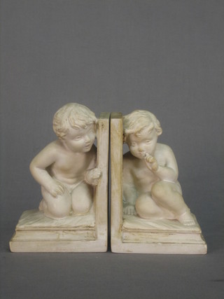 A pair of plaster book ends in the form of seated children (1f) 7"