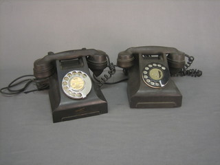 A pair of black Bakelite dial telephones, 1 base marked 4590D TFG and 1 marked 332CB