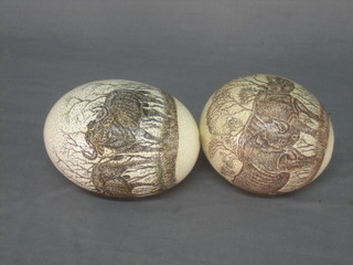 2 carved ostrich eggs