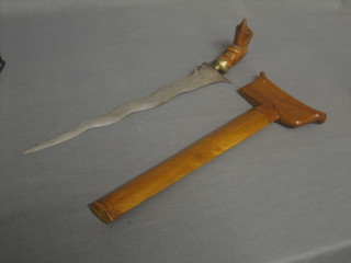 An Eastern Kris with 12 1/2" etched blade contained in a hardwood scabbard