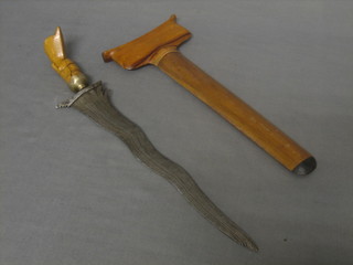 An Eastern Kris with 10" blade contained in a hardwood scabbard