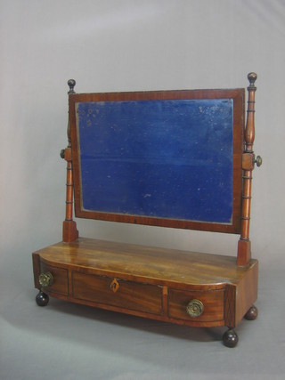 A Georgian rectangular bevelled plate dressing table mirror contained in a mahogany swing frame, the base fitted 1 long drawer flanked by 2 short drawers, raised on bun feet 21"