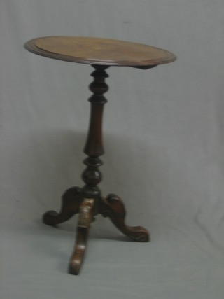 A circular Victorian inlaid figured walnut wine table, raised on pillar and tripod supports 18"