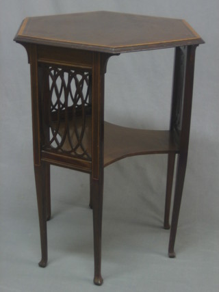 An Edwardian octagonal inlaid mahogany 2 tier occasional table with fretted panels to the side and having a triform shaped undertier, raised on square tapering supports 23"