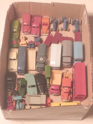 A collection of miniature toy cars including tractors etc