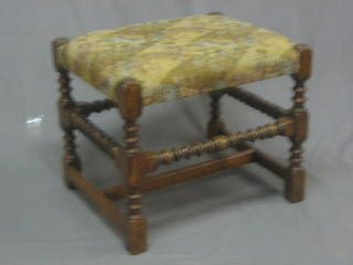 A reproduction 17th Century oak stool raised on turned and block supports 22", base marked Tozer of London