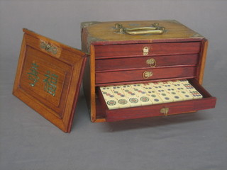 An ivory and bamboo Mahjong set contained in a wooden carrying case