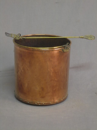 A copper coal bucket with swing handle and a brass poker decorated the Arms of Cambridge University