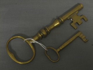 A large brass key 9" and 1 other