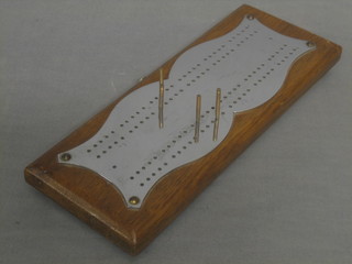 An oak and chromium plated cribbage board