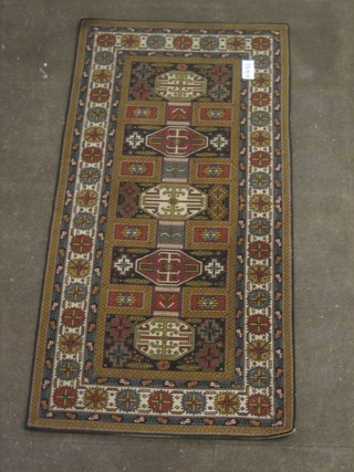 A Wilton machine ground Eastern style rug with 5 octagons to the centre within multi-row borders 73" x 37"