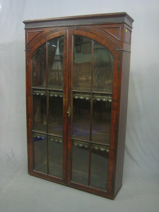 A Georgian mahogany bookcase top with moulded cornice, the interior fitted shelves enclosed by arch shaped astragal glazed panelled doors 34"