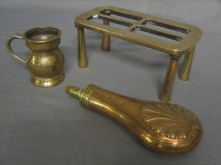 A copper and brass powder flask, a rectangular brass footman 8" and a brass bell shaped measure (3)