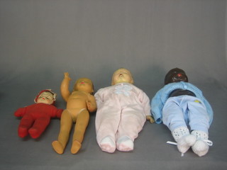 A black plastic headed doll with 3 other dolls