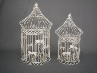 A pair of decorative white metal bird cages