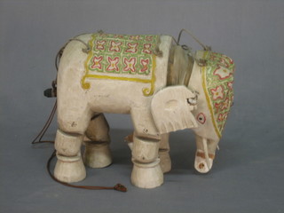 An Eastern model puppet in the form of an elephant with articulated legs 10" (part of ear missing)