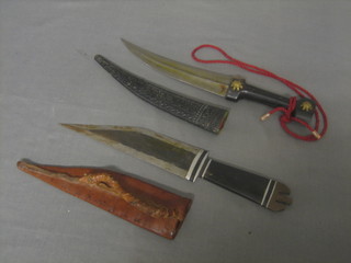 An Eastern dagger with 7" blade and leather scabbard together with 1 other contained in a leather scabbard