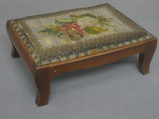 A Victorian rectangular walnut stool with bead work top, raised on bracket feet 13"