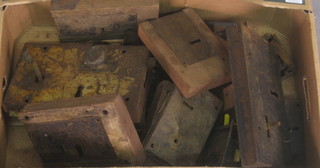 A box containing a collection of various antique door locks