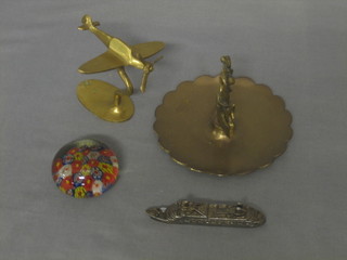A brass model of the Canberra 4", a do. Spitfire, a brass ashtray and a glass paperweight