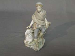 A Lladro figure group of a seated Shepherd and Lamb 9"