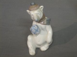 A Lladro figure of a polar bear with handkerchief and woolly hat 6 1/2"