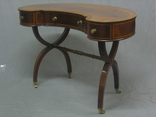 An Edwardian inlaid mahogany kidney shaped writing/dressing table, the crossbanded top inlaid satinwood stringing, raised on X framed supports with turned stretcher 40"