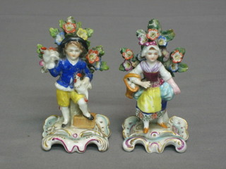 A pair of Continental porcelain arbour figures of boy and girl 4 1/2"