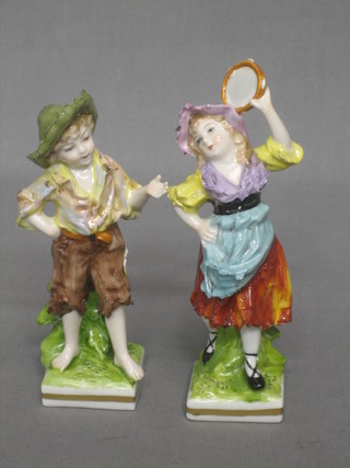 A German porcelain figure of a standing girl and a similar figure of a boy, bases with anchor mark and BS