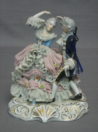 A 20th Century Continental porcelain figure of a dancing Crinoline lady and gentleman 9"