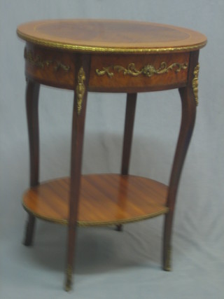 A French oval Kingwood 2 tier occasional table, the top fitted a drawer and inlaid satinwood stringing, raised on cabriole supports with gilt metal mounts throughout 21"